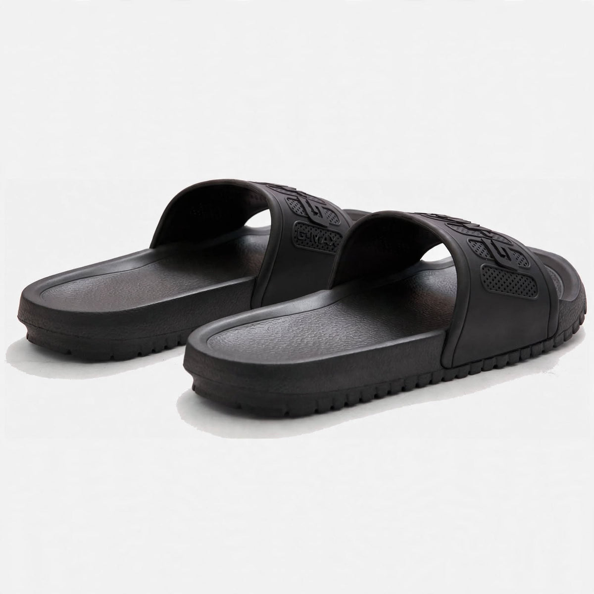 Matte black slide sandals, angled pair view