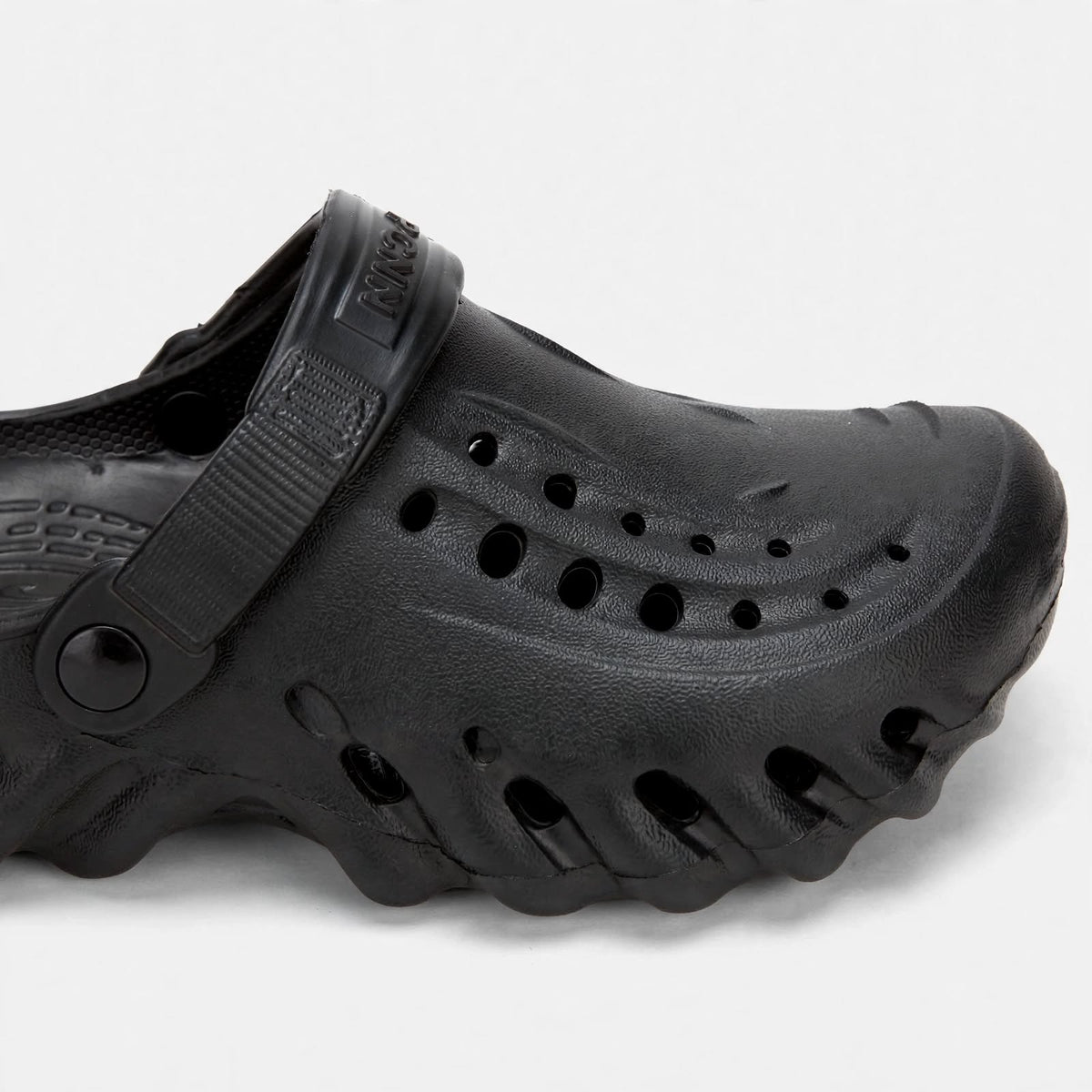 Men's black clog - close-up studio shot of material