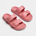Pink double-buckle slide sandals, top-down view