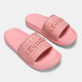 Soft pink slide sandals, angled studio pair view