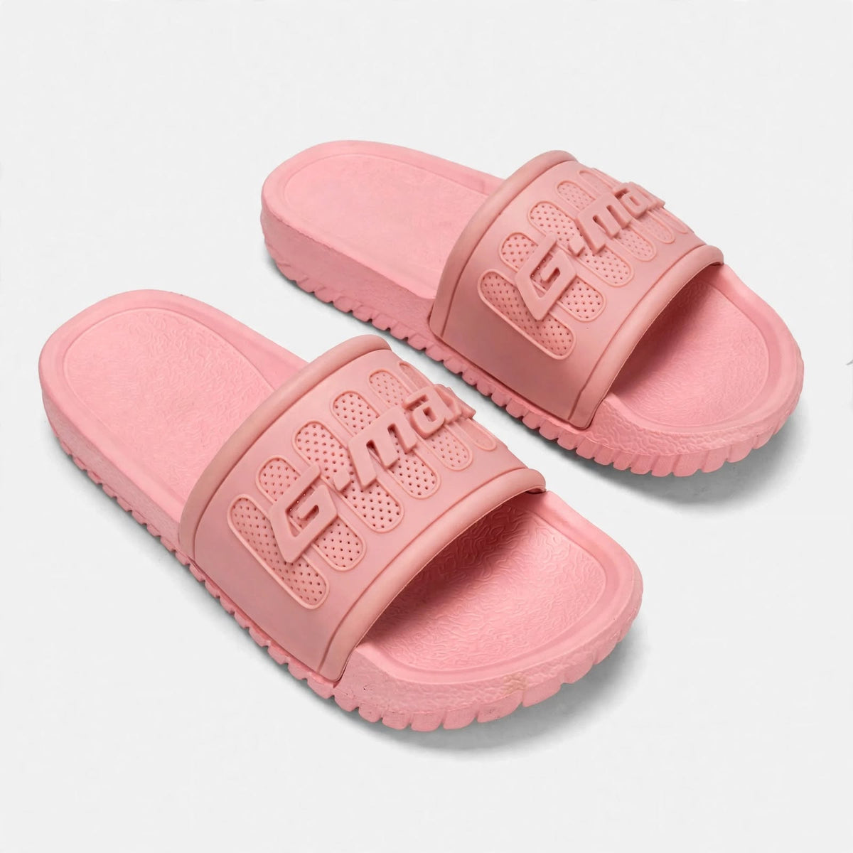 Soft pink slide sandals, angled studio pair view