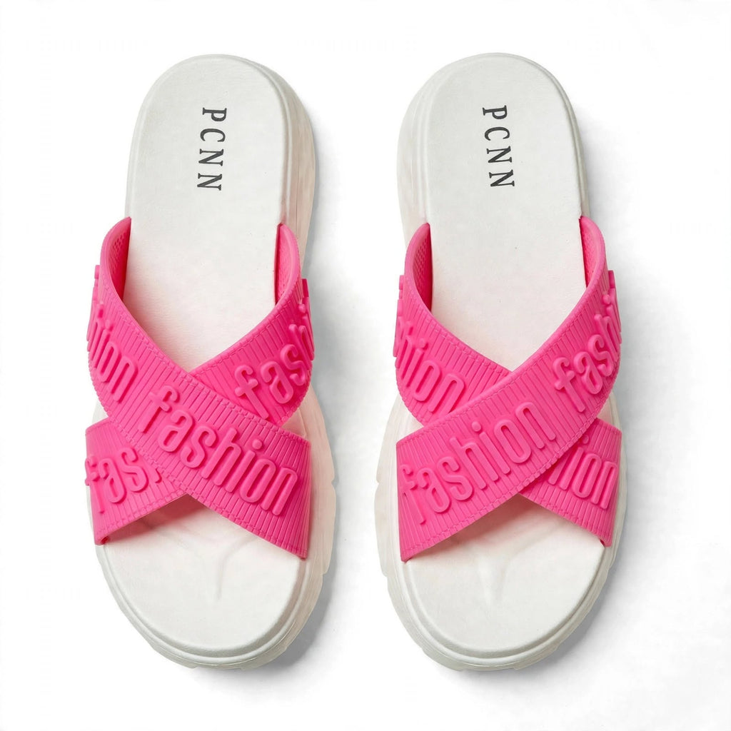 Pink slide sandals showing solid white outsole